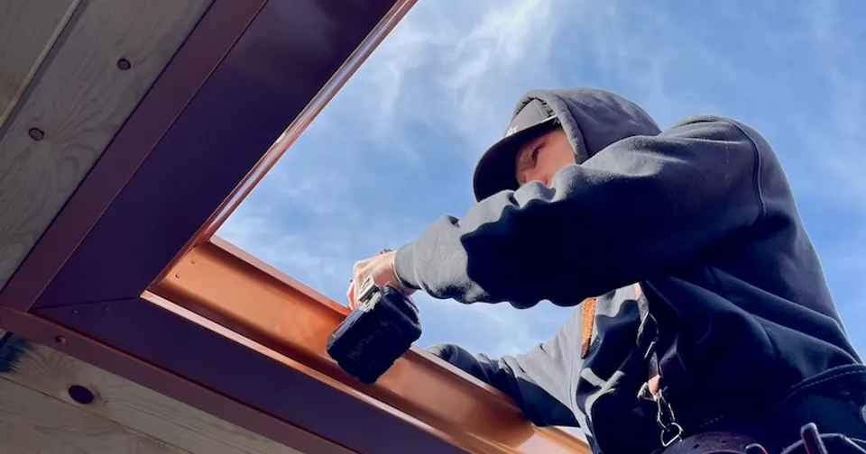 Badlands crew installing seamless gutters on a home